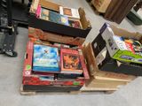 several boxes of books are stacked on top of each other on the floor