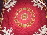 a red table cloth with white horses on it