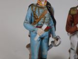 two figurines of a man and a woman dressed in uniforms