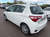 the back of a white toyota yaris parked in a parking lot