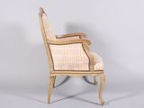 an old fashioned chair with a stripped upholstered back and arms