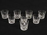 six shot glasses are lined up in a row on a black background