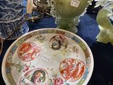 Plusieurs vases et assiettes sont posés sur une table dans une pièce