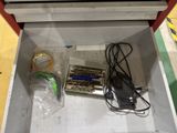 a box that has a charger and other items in it