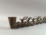 a pipe that is sitting next to a pipe holder