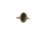 a close up of a gold ring with a green stone in it
