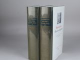 two books sitting on top of each other in front of a gray background
