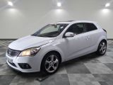 the white car is parked on a checkered floor in the garage