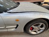 a car that has been damaged and is sitting on the street
