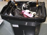 a black box with a handle on it sitting on the floor