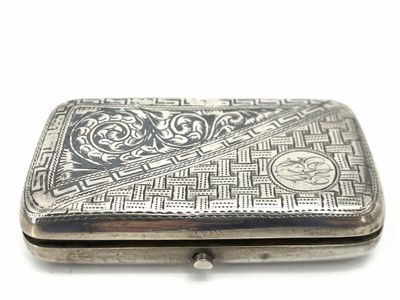an antique silver cigarette case with a design on the front