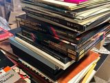 many books stacked on top of each other on a table