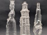 three clear glass vases sitting next to each other on a table