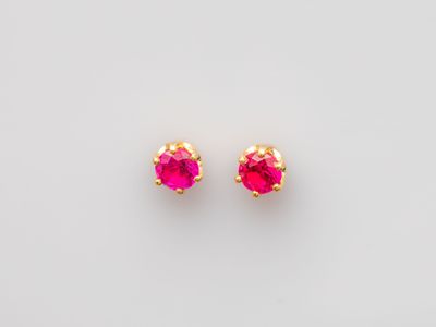 a pair of pink stone stud earrings on a white background