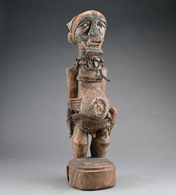 a wooden statue of a man holding a guitar