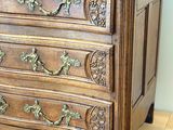 a wooden chest of drawers on wheels on a hard wood floor