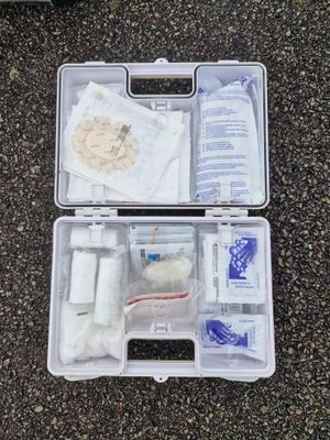 a plastic case filled with medical supplies sitting on the ground