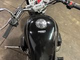 a black motorcycle that is parked in a garage