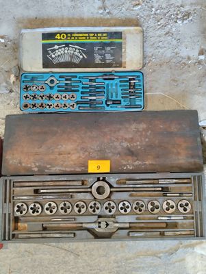 a box of tools sitting on the floor next to a box of tools