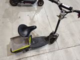 a scooter that is sitting on the ground next to a scooter