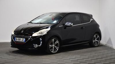 a black car parked in a room with a checkered floor