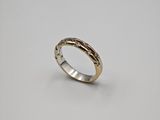 a close up of a gold ring on a white background
