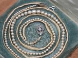 a picture of a jewelry box with pearls on it