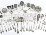 a lot of spoons and silverware on the table