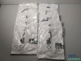 two bags of white t - shirts sitting on top of a table