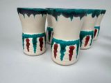 three cups that are sitting next to each other on a table