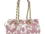a pink and white purse with a gold chain handle