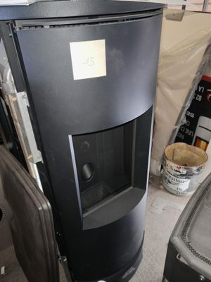 an image of a black stove in a garage