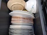 a lot of plates and bowls in a plastic container