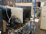 a lot of computer equipment on a cart in a warehouse