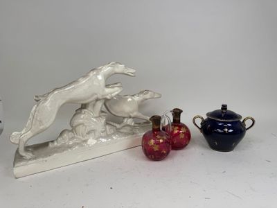 two vases and a statue of a dog on a table