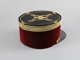 a small red box with a black and gold design on it