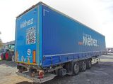a blue semi truck with a qr code on the back