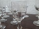 several empty wine glasses sitting on top of a wooden table