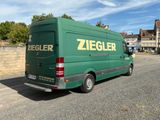 a green van that is parked on the side of the road