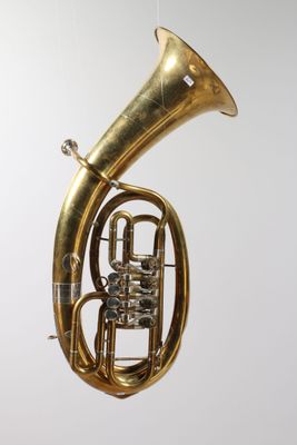 an image of a brass instrument hanging from a string