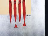 three red fish that are hanging from the ceiling