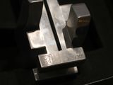 a close up of a metal object on a black surface