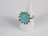 a close up of a ring with a blue stone on it
