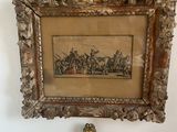 two framed pictures hanging on the wall above a toilet