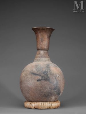 an old vase with a wooden stand on a gray background