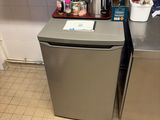 a small kitchen with a stainless steel refrigerator and dishwasher
