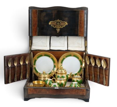 a wooden box with a tea set inside of it