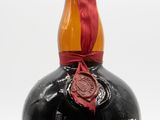 an image of a bottle of liquor with a wax seal on top of it
