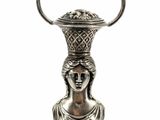 an image of a silver vase shaped like a woman with a basket on her head