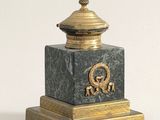 a gold and black clock with a dragon on it